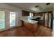 Functional kitchen with stainless steel appliances, ample counter space, and wood flooring at 13385 Ne 10Th Ct, Citra, FL 32113