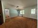 Inviting living room featuring neutral paint, ceiling fan and entry door with decorative glass at 13385 Ne 10Th Ct, Citra, FL 32113