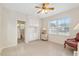 Bright bedroom with large window, built-in cabinetry and en-suite bath, creating a comfortable and private suite at 13495 Se 93Rd Court Rd, Summerfield, FL 34491