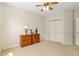 Bedroom with wooden dresser, sliding door closet and ceiling fan at 13495 Se 93Rd Court Rd, Summerfield, FL 34491