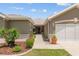 Beautifully landscaped walkway to the front door in this home with neutral tones at 13495 Se 93Rd Court Rd, Summerfield, FL 34491