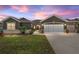 Charming home with a well-manicured lawn, neutral paint colors, and a convenient two-car garage at 13495 Se 93Rd Court Rd, Summerfield, FL 34491