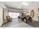 Spacious garage featuring an automobile, and overhead door with windows, and ample storage at 13495 Se 93Rd Court Rd, Summerfield, FL 34491
