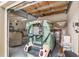 Well-organized garage featuring a golf cart and classic car, providing secure parking and storage options at 13495 Se 93Rd Court Rd, Summerfield, FL 34491