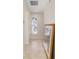 Hallway with tile floors and a decorative window, featuring a large framed picture on the floor at 13495 Se 93Rd Court Rd, Summerfield, FL 34491