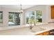 Kitchen featuring a stainless steel sink with backyard views and access to the lanai at 13495 Se 93Rd Court Rd, Summerfield, FL 34491