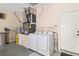 Functional laundry area with modern washer and dryer, water heater and water softener, offering convenience and efficiency at 13495 Se 93Rd Court Rd, Summerfield, FL 34491