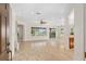 Bright and spacious living area featuring tile floors, large windows, and views of the outdoors at 13495 Se 93Rd Court Rd, Summerfield, FL 34491