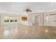 Open-concept living space with tile flooring, a fireplace, and a view into the kitchen area at 13495 Se 93Rd Court Rd, Summerfield, FL 34491