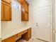 Convenient mud room with built-in desk, cabinets, and easy access to the home's exterior at 13495 Se 93Rd Court Rd, Summerfield, FL 34491