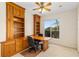 Cozy office space with custom wood built-ins, golf course views, and convenient outdoor access at 13495 Se 93Rd Court Rd, Summerfield, FL 34491