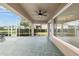Spacious covered patio, complete with screened enclosure, ceiling fan, and serene golf course views at 13495 Se 93Rd Court Rd, Summerfield, FL 34491