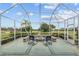 Relax in this screened lanai with a cozy fire pit and views of the golf course at 13495 Se 93Rd Court Rd, Summerfield, FL 34491