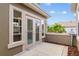Cozy patio with tiled flooring and French doors, surrounded by lush greenery, offering a serene outdoor retreat at 13495 Se 93Rd Court Rd, Summerfield, FL 34491
