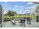 Enjoy outdoor living on this screened-in patio featuring a fire pit and golf course views at 13495 Se 93Rd Court Rd, Summerfield, FL 34491
