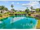 Picturesque pond with a waterfall feature, surrounded by lush landscaping and well-manicured lawns at 13495 Se 93Rd Court Rd, Summerfield, FL 34491