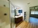 Clean bathroom featuring a wood cabinet vanity, a shower and an adjacent room at 14117 Sw 115Th Cir, Dunnellon, FL 34432