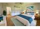 This bedroom features a ceiling fan, white walls, a king bed, and a walk-in closet at 14117 Sw 115Th Cir, Dunnellon, FL 34432