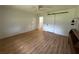 Bright bedroom with wood-look flooring and a sliding barn door to the walk-in closet at 14117 Sw 115Th Cir, Dunnellon, FL 34432