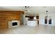 Living room features a fireplace and a kitchen with modern lighting, and neutral tile floors at 14117 Sw 115Th Cir, Dunnellon, FL 34432