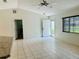 Bright living room featuring tiled floor, ceiling fan, and natural light from the window at 14117 Sw 115Th Cir, Dunnellon, FL 34432