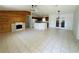 Open living room with wood accent wall fireplace and eat-in kitchen with plenty of natural light at 14117 Sw 115Th Cir, Dunnellon, FL 34432