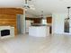 Bright open living room with wood accent wall fireplace, tile floors and eat-in kitchen at 14117 Sw 115Th Cir, Dunnellon, FL 34432