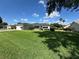 Well-maintained home exterior with lush green lawn and mature trees at 14117 Sw 115Th Cir, Dunnellon, FL 34432