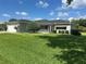 Charming single-story home featuring a well-manicured lawn, mature landscaping, and attached two-car garage at 14117 Sw 115Th Cir, Dunnellon, FL 34432