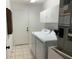 Functional laundry room with white cabinets, a washer, and a dryer at 14117 Sw 115Th Cir, Dunnellon, FL 34432