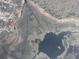Aerial view showing the property outlined in red, nestled near a lake and surrounding vegetation at 1675 Se 190Th Ave, Silver Springs, FL 34488