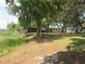 The property includes a backyard with lush grass, a lake and mature trees at 1675 Se 190Th Ave, Silver Springs, FL 34488