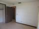 Bright bedroom with carpet flooring, neutral walls, and adjoining doorway at 1675 Se 190Th Ave, Silver Springs, FL 34488