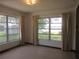 Bedroom with large windows and neutral curtains offering natural light and a view of the outdoors at 1675 Se 190Th Ave, Silver Springs, FL 34488
