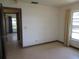 Well-lit bedroom with carpet flooring, neutral paint, and window with curtains at 1675 Se 190Th Ave, Silver Springs, FL 34488