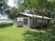 Exterior view of a home with a screened-in porch and lakeside views at 1675 Se 190Th Ave, Silver Springs, FL 34488