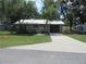 Charming single-story home with a well-maintained lawn, mature trees, and a concrete driveway at 1675 Se 190Th Ave, Silver Springs, FL 34488