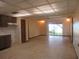 Open living room with tile floors, adjacent kitchen, and sliding glass doors to the lake view at 1675 Se 190Th Ave, Silver Springs, FL 34488