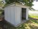 Exterior of a small white storage shed with an open door at 1675 Se 190Th Ave, Silver Springs, FL 34488