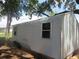 Storage shed exterior features corrugated metal and a single window at 1675 Se 190Th Ave, Silver Springs, FL 34488