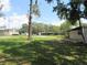Spacious yard with mature shade trees and views of multiple buildings at 1675 Se 190Th Ave, Silver Springs, FL 34488