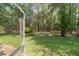 View of the wooded backyard from the screened porch, offering privacy and a serene natural setting at 18328 Sw 73Rd Loop, Dunnellon, FL 34432