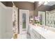 Neutral bathroom with white vanity, full mirror, shower and private entrance to the backyard at 18328 Sw 73Rd Loop, Dunnellon, FL 34432