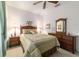 Well-lit bedroom featuring a wooden bed frame, dresser, and soft natural-colored carpet at 18328 Sw 73Rd Loop, Dunnellon, FL 34432
