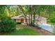 Inviting single-story home with a well-manicured lawn and colorful orange front door at 18328 Sw 73Rd Loop, Dunnellon, FL 34432