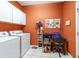 Laundry/Utility room with washer, dryer, workspace and orange painted walls at 18328 Sw 73Rd Loop, Dunnellon, FL 34432