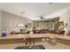 Open floorplan shows living room with ceiling fan, breakfast nook and kitchen bar with sink at 18328 Sw 73Rd Loop, Dunnellon, FL 34432