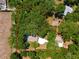 Aerial view showcasing the property's lot size, including the home, garage, and surrounding trees at 200 Se 145Th St, Summerfield, FL 34491