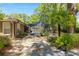 Landscaped backyard with a screened-in pool enclosure, lush plants, and stone pathways, creating a private retreat at 200 Se 145Th St, Summerfield, FL 34491