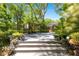 Spacious wooden deck surrounded by lush landscaping and mature trees, creating a serene outdoor space at 200 Se 145Th St, Summerfield, FL 34491